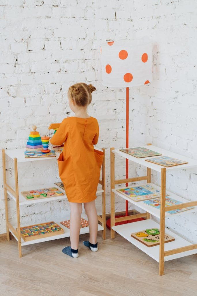 A young girl plays with educational toys in a colorful preschool classroom setting.